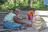 Teramira wraps dried pandanus leaves into large rolls. I-Kiribati women use these leaves to weave a variety of household products, such as mats, curtains, and traditional clothing.