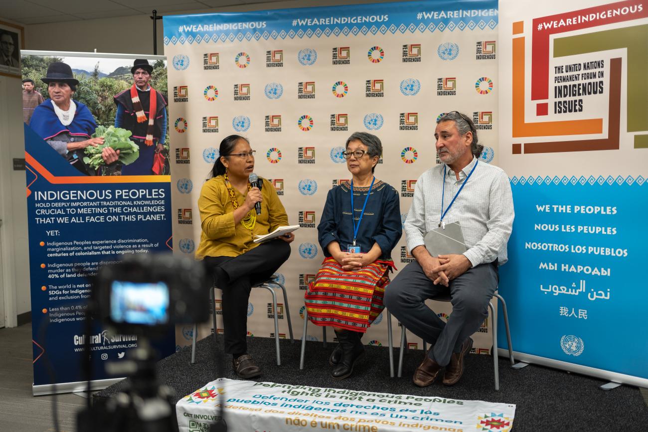 Cristina Coc (Maya Q’eqchi), Advocacy Coordinator at Indigenous Peoples Rights International (IPRI) moderating  panel "Criminaliza- tion of Indigenous  Peoples’ Rights" organized by IPRI in the Indigenous Media Zone at the UNPFII in April 2024, with Victoria Tauli-Corpuz (Kankanaey Igorot) and Fergus McKay.  Photo by Jamie Malcolm- Brown/Cultural Survival.