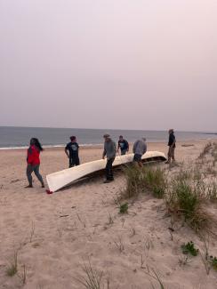 Preparing for the paddle across the Long Island sound at Weekapaug Beach. Photo taken by Grounds crew